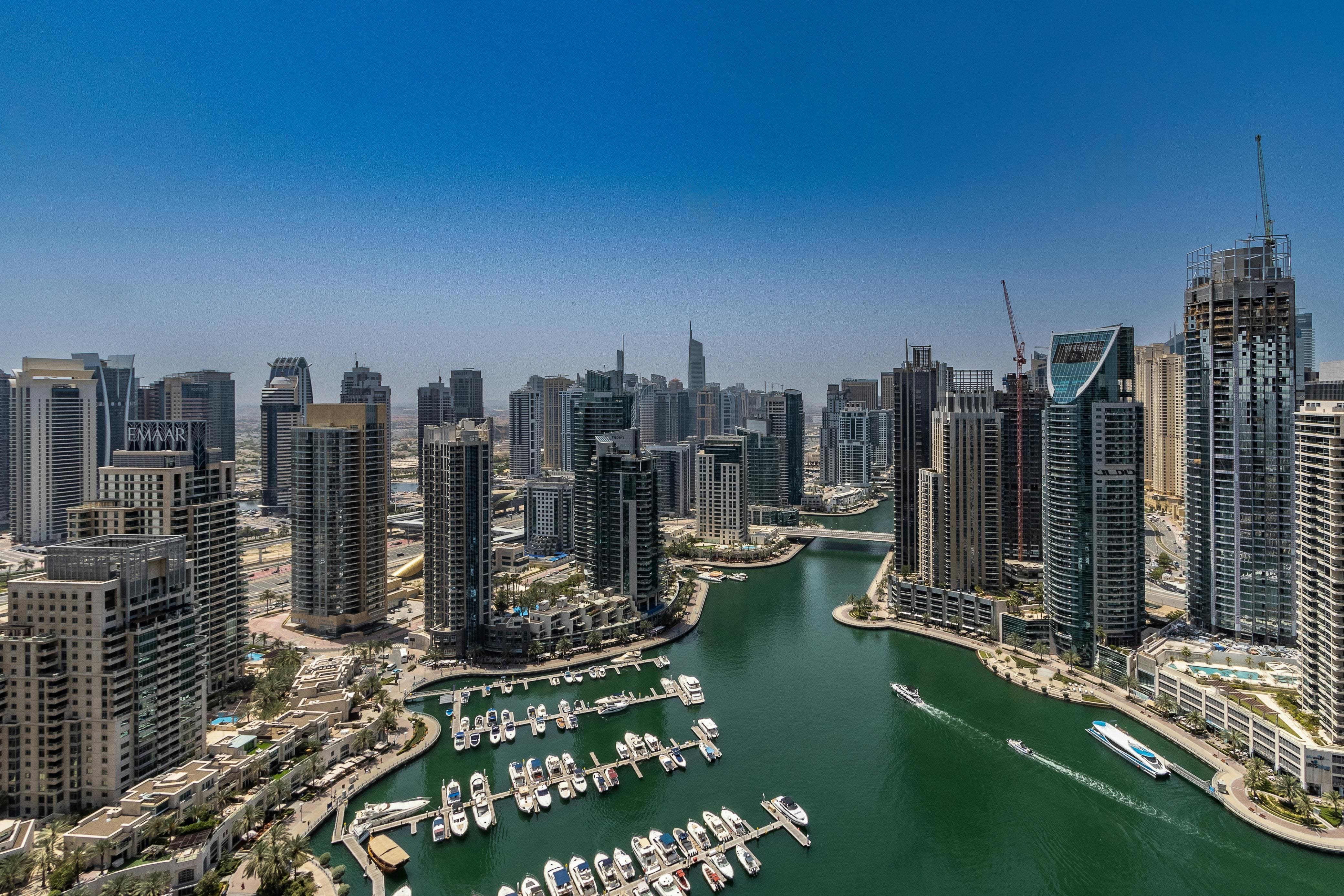Dubai harbour with boats and cityscape