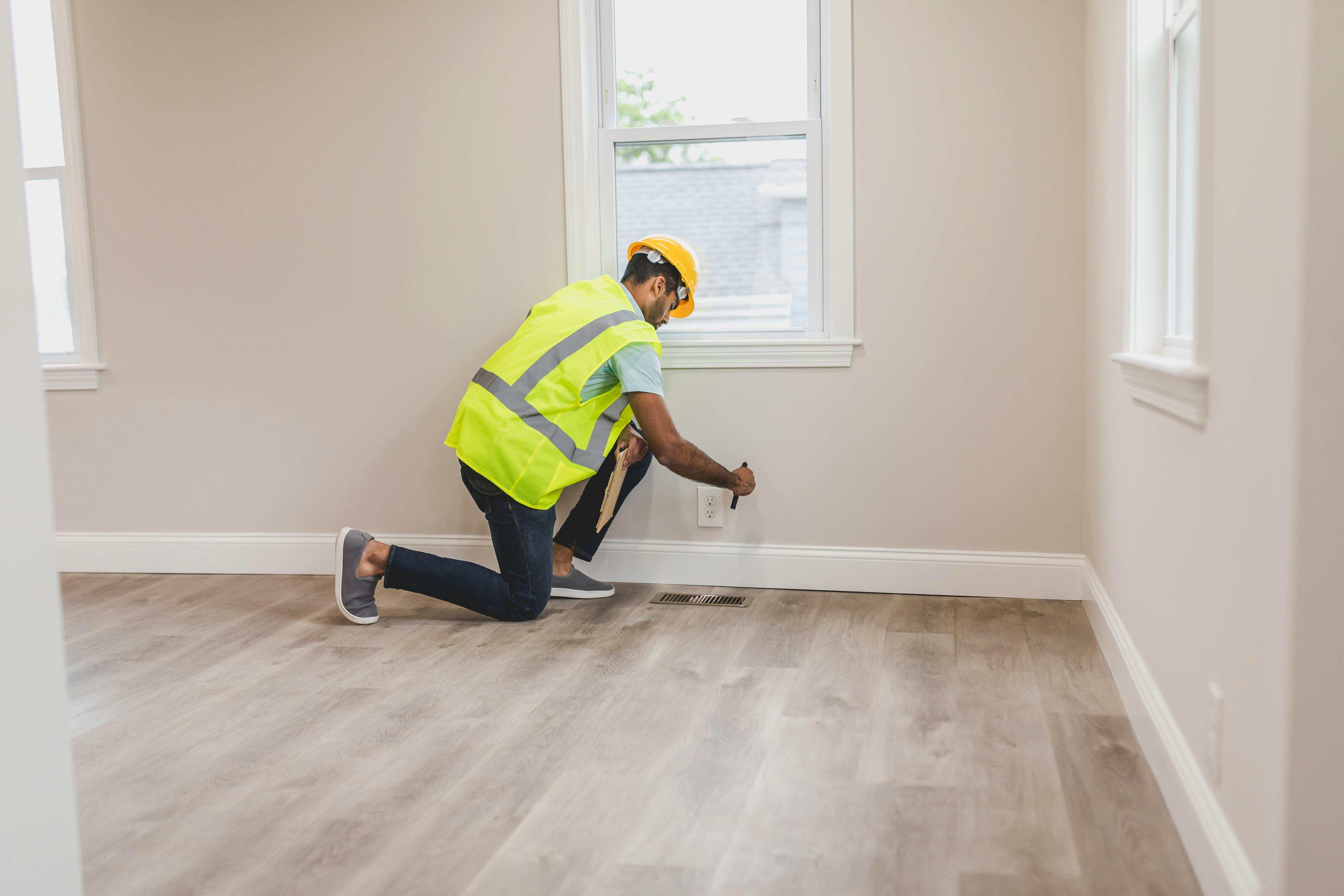 Inspector checking electrical socket during evaluation