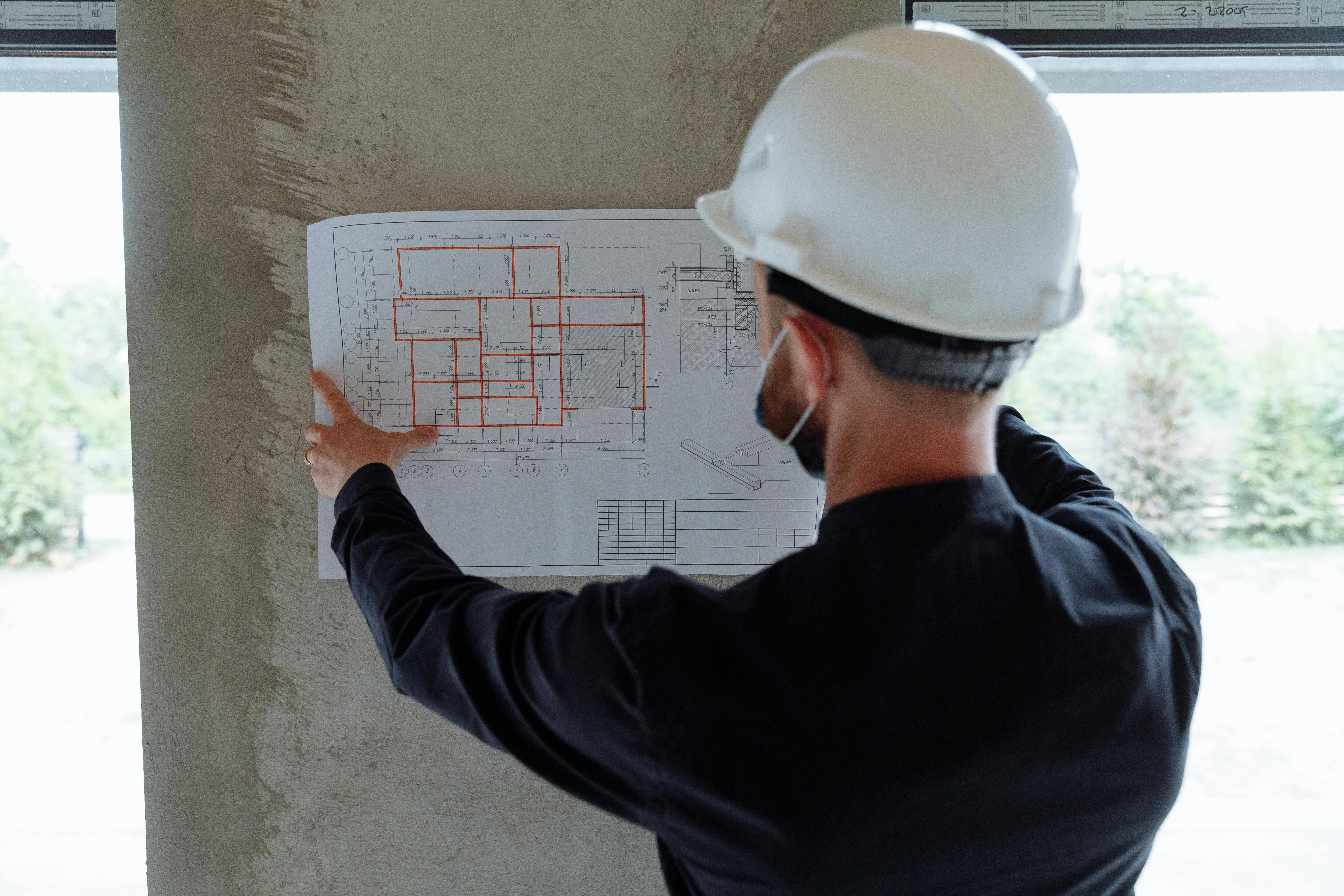 Surveyor reviewing blueprints to select test type